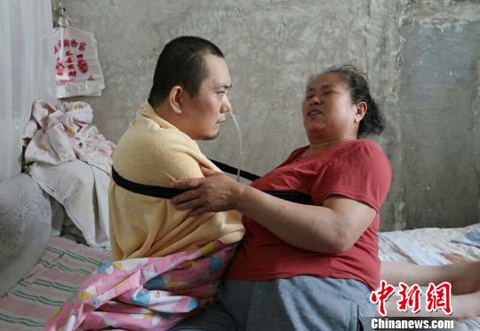 身體日漸衰老的梁青蘭每次幫兒子翻身、坐立，全身的衣物都要濕透一次?！∩忻鱾b 攝